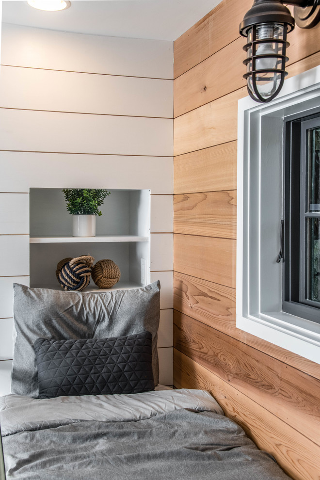 Organic Modern Mountain Home - A rustic kids' room designed for ages 4 to 10, featuring cozy double deck beds, soft gray carpet flooring, and a warm, playful ambiance. This functional and eco-friendly space is part of the sustainable organic modern mountain home.
