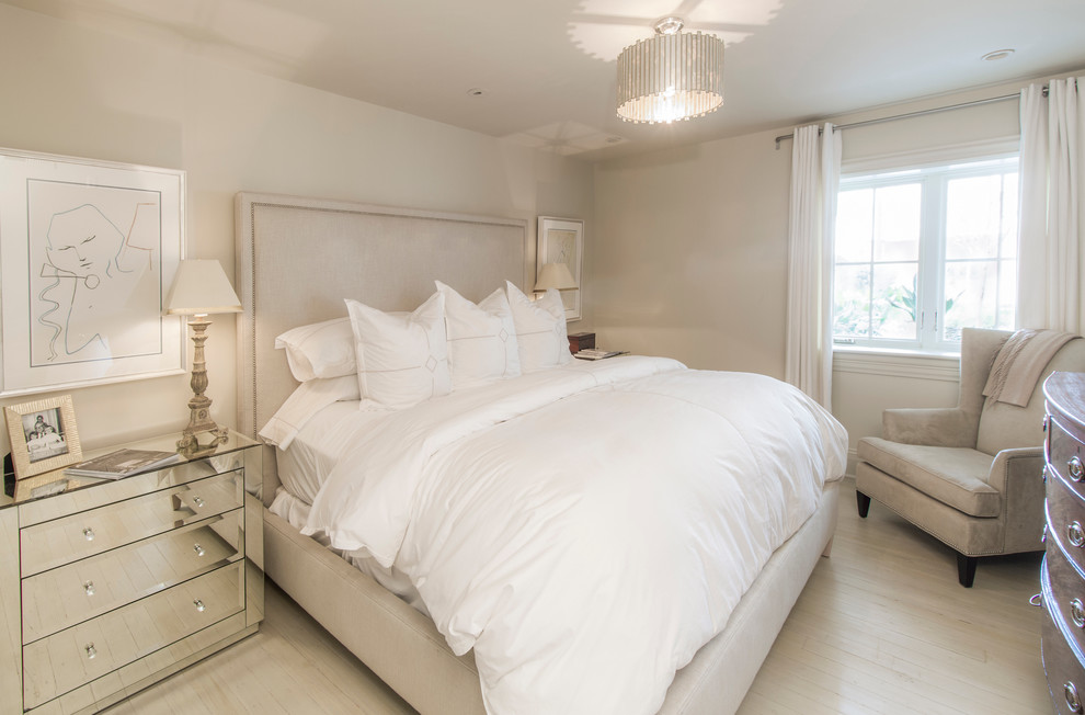 Mid-sized transitional master bedroom in New Orleans with beige walls and painted wood floors.