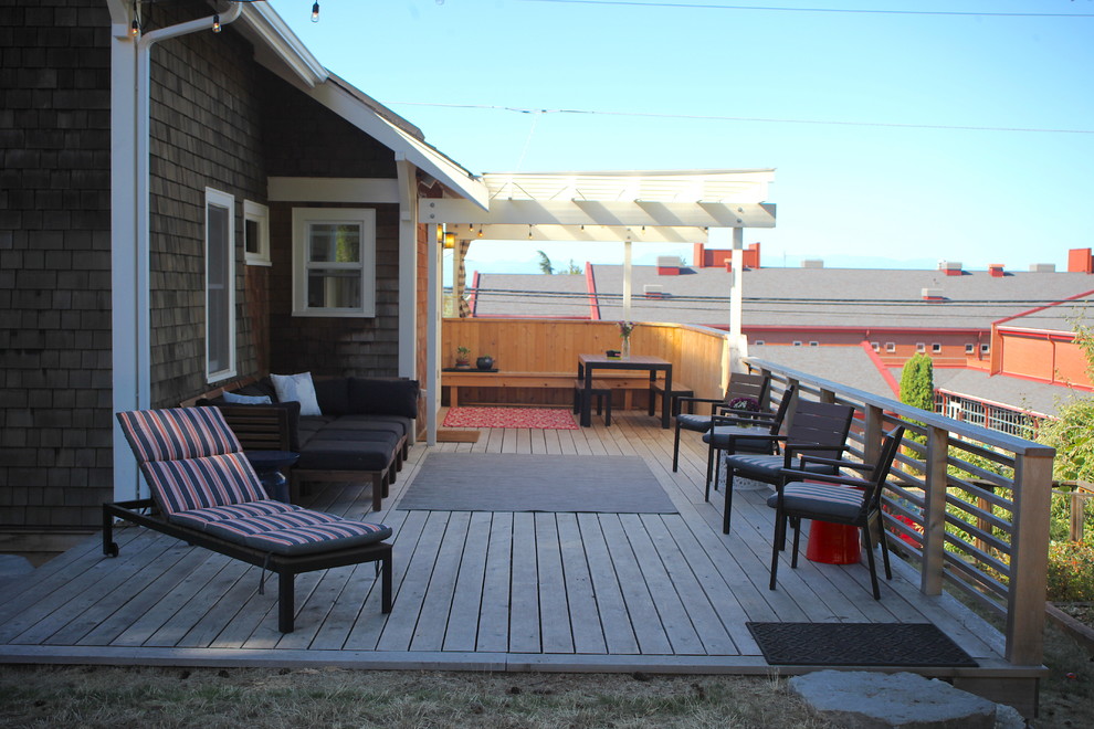 Mid-sized arts and crafts backyard deck photo in Seattle with a pergola