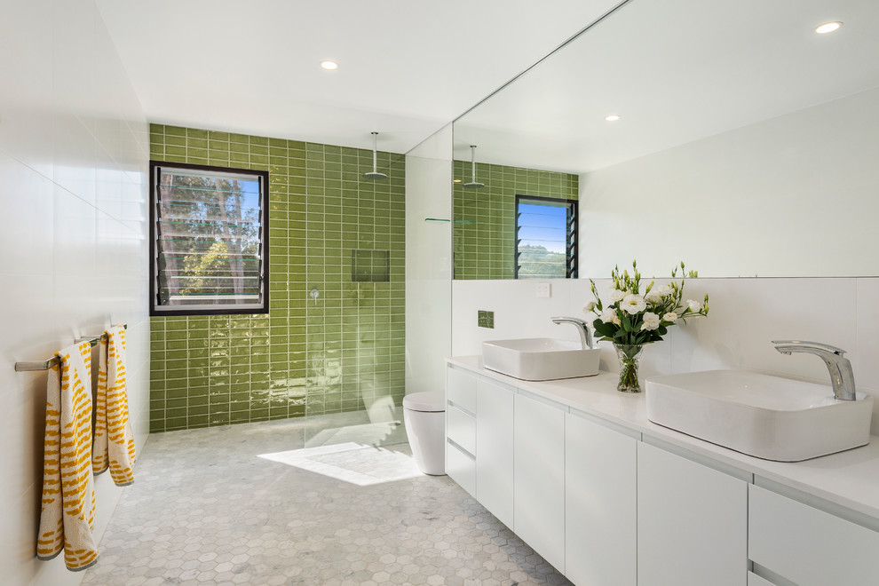 Inspiration for a mid-sized contemporary kids bathroom in Sydney with white cabinets, a one-piece toilet, green tile, cement tile, white walls, marble floors, a vessel sink, white floor, an open shower, flat-panel cabinets, a curbless shower and white benchtops.