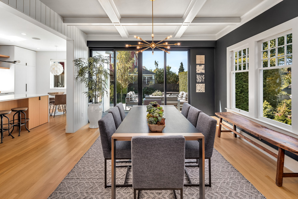 This is an example of a mid-sized contemporary open plan dining in Seattle with grey walls, light hardwood floors and coffered.