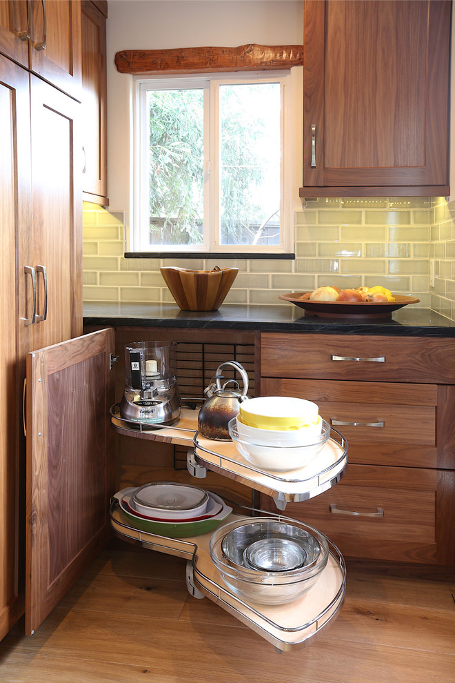 Inspiration for a small country galley open plan kitchen in Other with an undermount sink, flat-panel cabinets, medium wood cabinets, soapstone benchtops, grey splashback, subway tile splashback, stainless steel appliances, medium hardwood floors and a peninsula.