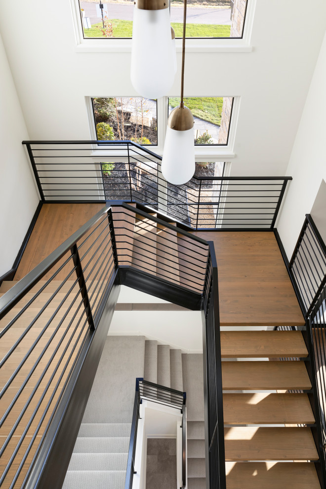 Inspiration for a country wood floating staircase in Minneapolis with metal railing.