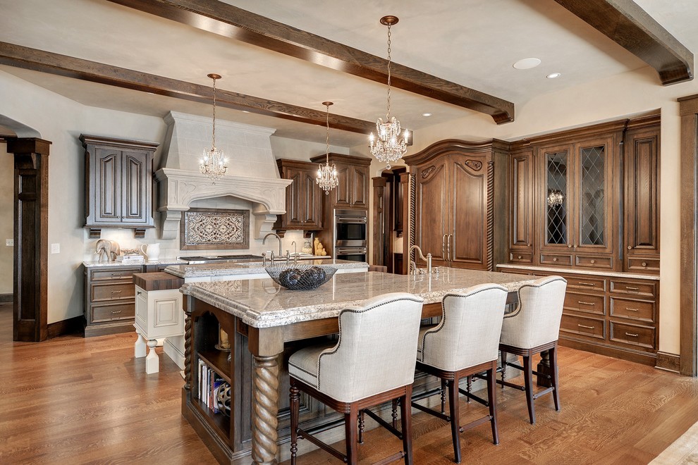 Inspiration for a timeless l-shaped medium tone wood floor open concept kitchen remodel in Minneapolis with raised-panel cabinets, medium tone wood cabinets, paneled appliances and beige walls