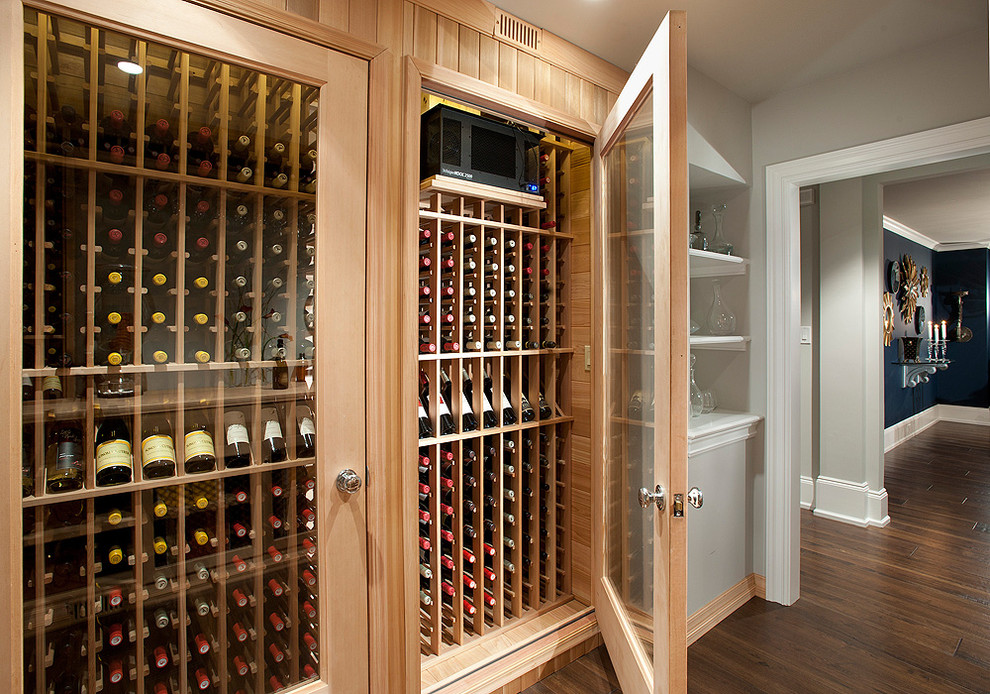 Design ideas for a small transitional wine cellar in Philadelphia with dark hardwood floors, storage racks and brown floor.