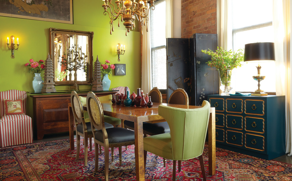 This is an example of an eclectic dining room in Chicago with green walls.