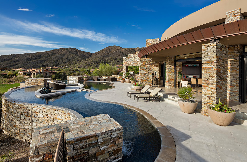 Pool fountain - rustic backyard custom-shaped pool fountain idea in Phoenix