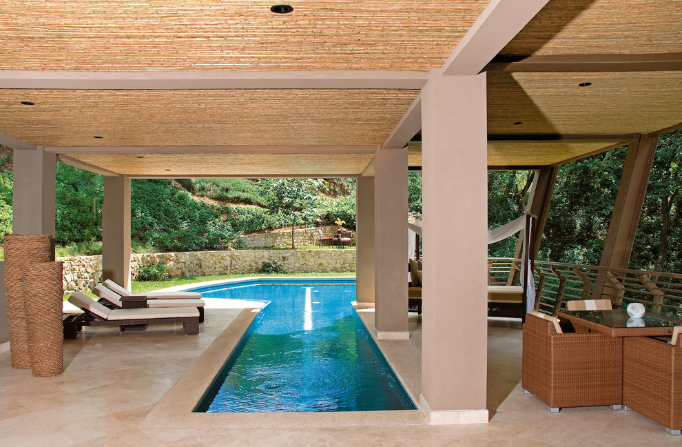 Photo of a mid-sized contemporary side yard custom-shaped lap pool in Other with tile.