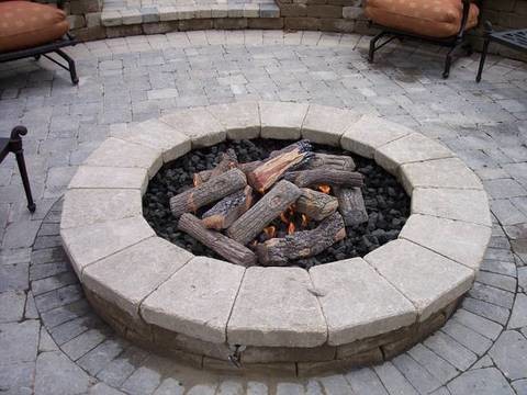 Inspiration for a mid-sized traditional backyard patio in Chicago with a fire feature, concrete pavers and no cover.