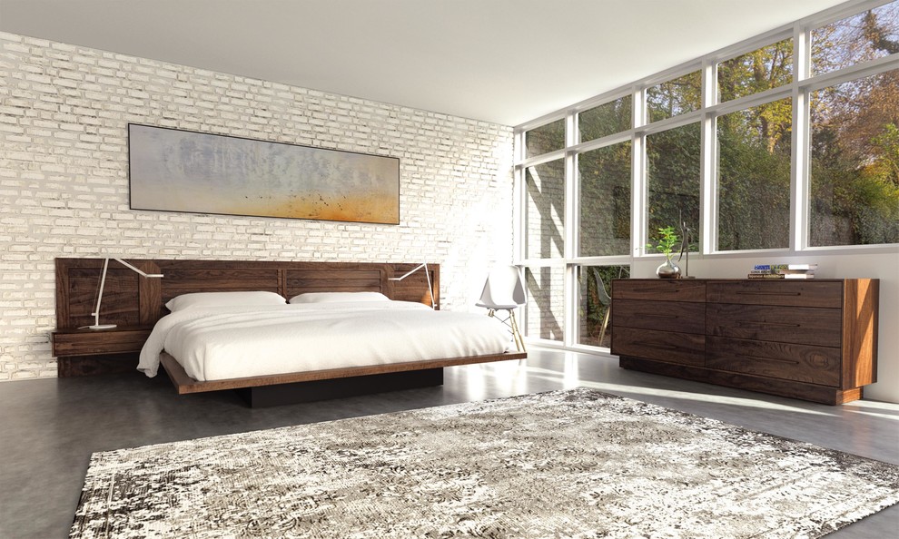 Large contemporary master bedroom in New York with white walls, concrete floors, no fireplace and grey floor.