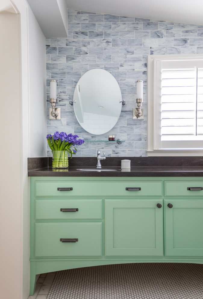 Cottage chic blue tile mosaic tile floor bathroom photo in Jacksonville with green cabinets, an undermount sink, black countertops and shaker cabinets