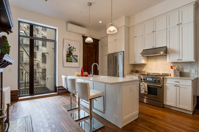 Urban Kitchen With Tall Ceilings And Nordic White Cabinets