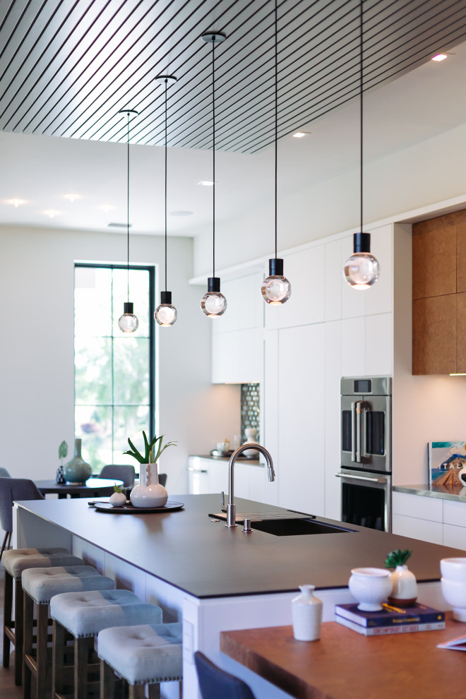 Foto di una cucina design chiusa con ante lisce, top piastrellato, paraspruzzi con piastrelle di vetro e soffitto in legno