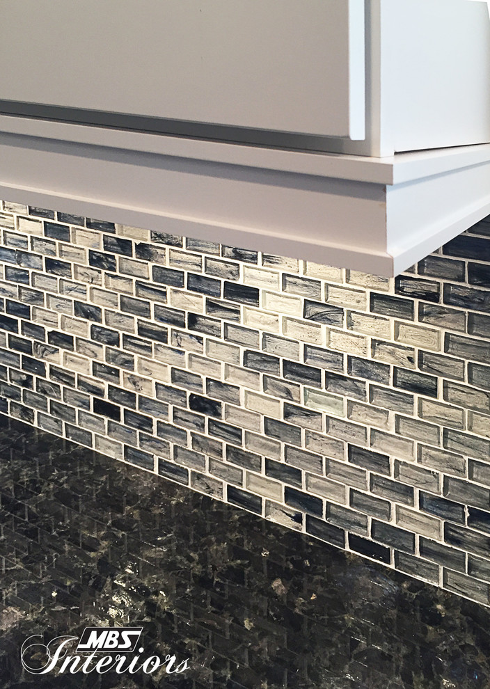Example of a mid-sized transitional galley ceramic tile and beige floor eat-in kitchen design with a farmhouse sink, white cabinets, stainless steel appliances, shaker cabinets, granite countertops, blue backsplash, glass sheet backsplash and an island