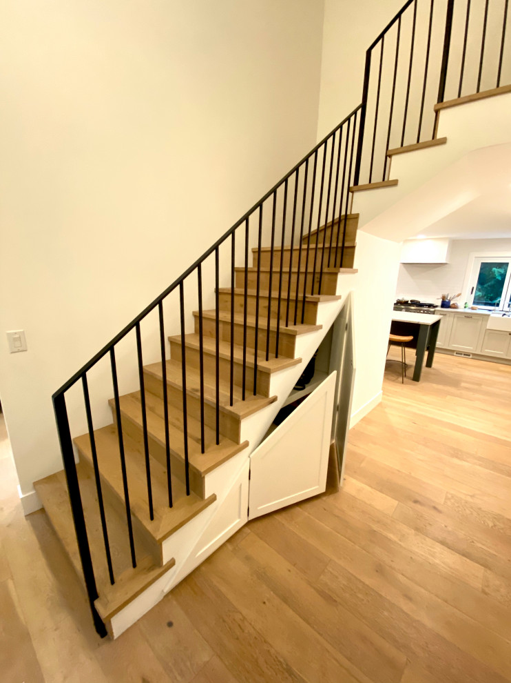 Inspiration for a mid-sized country wood l-shaped staircase in Seattle with wood risers and metal railing.