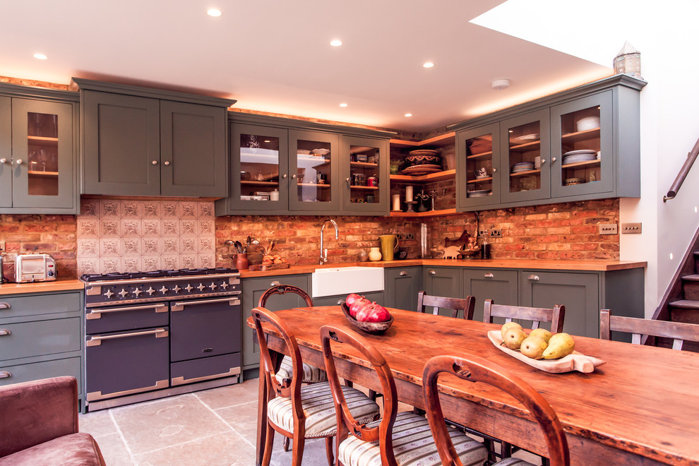 Mid-sized country l-shaped separate kitchen in London with a farmhouse sink, glass-front cabinets, grey cabinets, coloured appliances and no island.