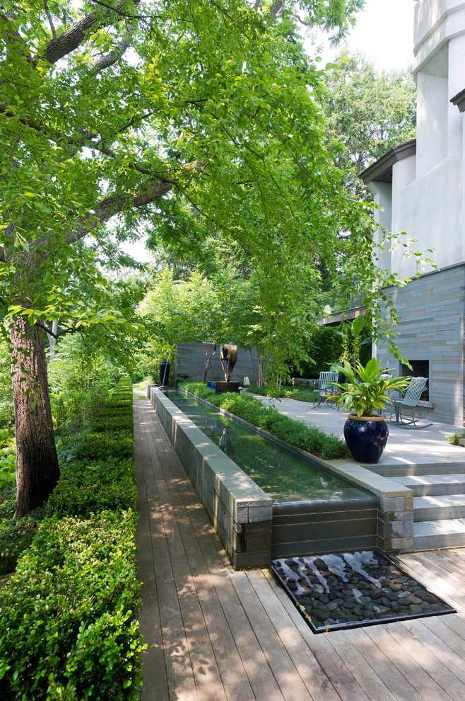 Photo of a contemporary garden in Boston with a water feature and decking.