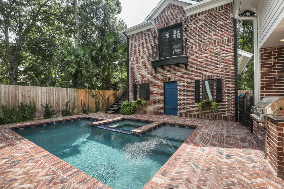 Design ideas for a large traditional backyard rectangular lap pool in Houston with a hot tub and brick pavers.
