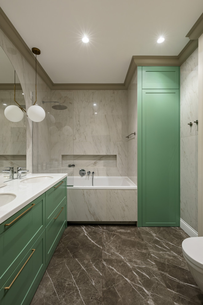 Photo of a medium sized classic ensuite bathroom in Saint Petersburg with raised-panel cabinets, green cabinets, a submerged bath, a shower/bath combination, a wall mounted toilet, beige tiles, porcelain tiles, beige walls, porcelain flooring, a submerged sink, solid surface worktops, brown floors, a shower curtain, white worktops, double sinks and a built in vanity unit.