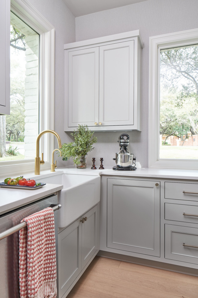 Example of a mid-sized transitional galley medium tone wood floor kitchen pantry design in Austin with beaded inset cabinets, green cabinets, multicolored backsplash, paneled appliances, an island, white countertops and a farmhouse sink