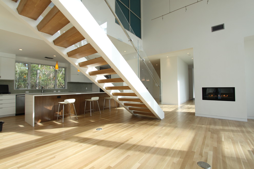 Inspiration for a contemporary wood straight staircase in Houston with open risers.