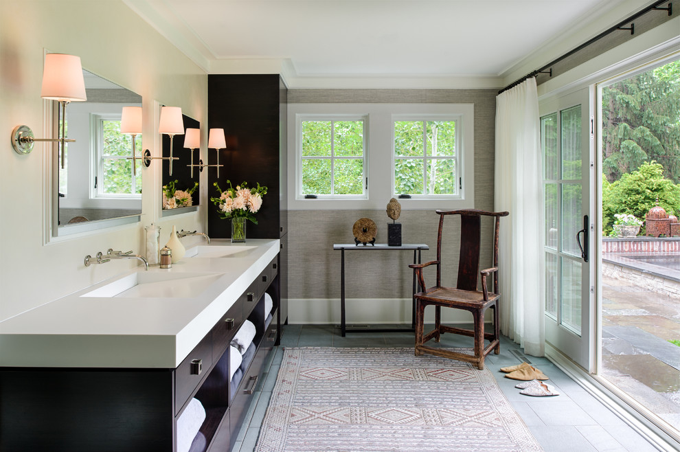 Photo of a mid-sized transitional master bathroom in Minneapolis with flat-panel cabinets, dark wood cabinets, an integrated sink and grey walls.