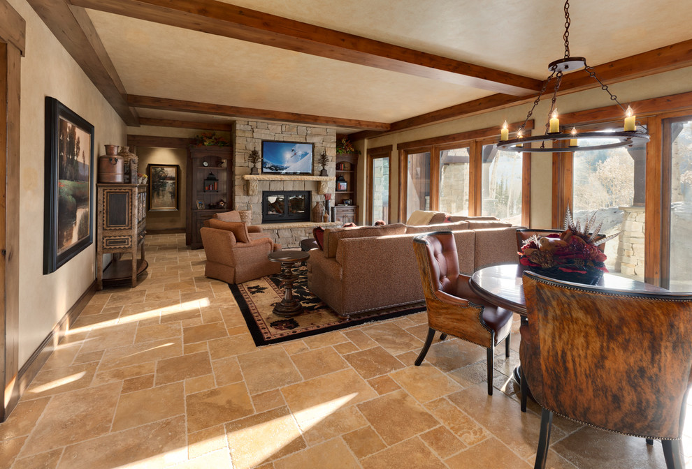 This is an example of an expansive arts and crafts formal open concept living room in Salt Lake City with beige walls, limestone floors, a standard fireplace, a stone fireplace surround and no tv.