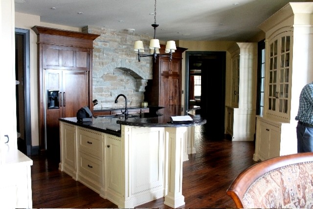 Dark wood floor kitchen photo with an island