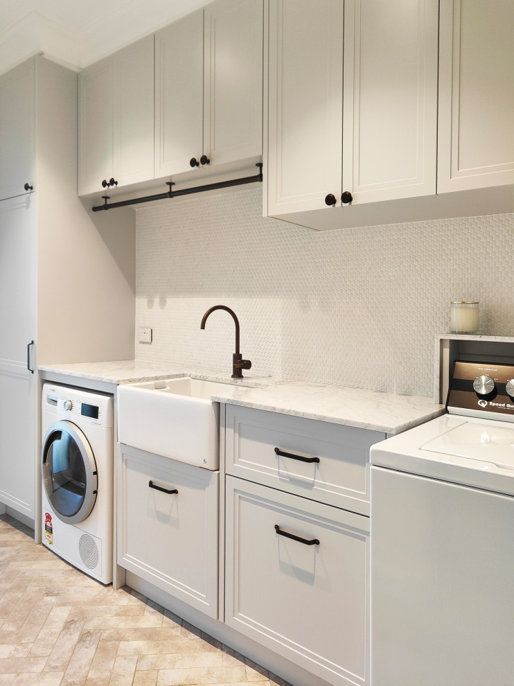 This is an example of a transitional laundry room in Sydney.