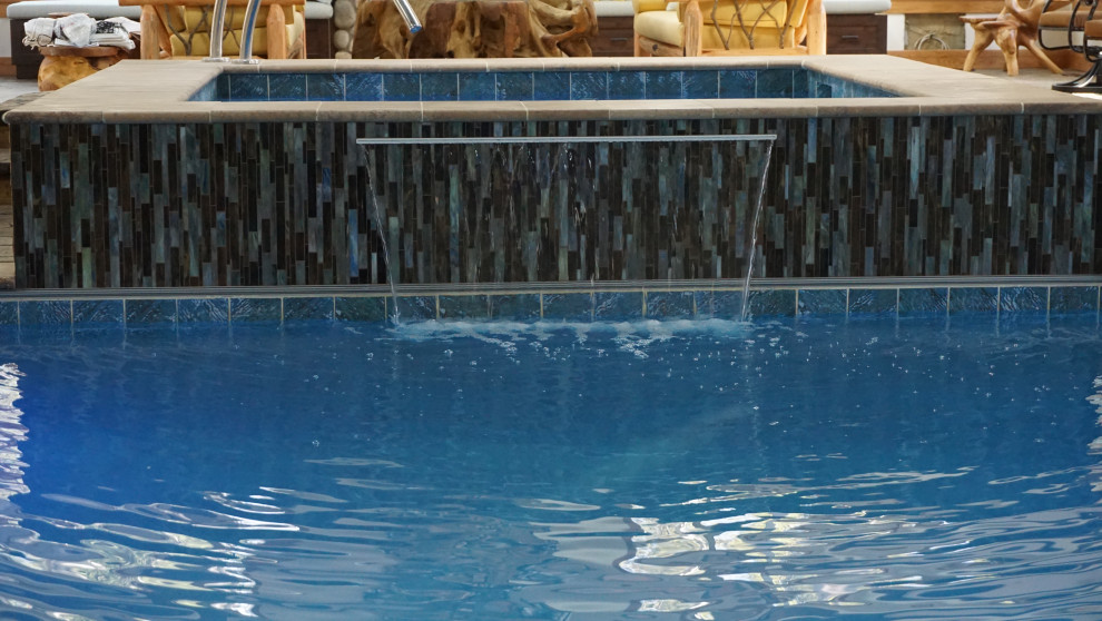 Mountain style pool photo in Calgary