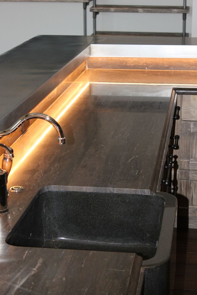 Mountain style home design photo in Phoenix with an integrated sink, distressed cabinets and limestone countertops