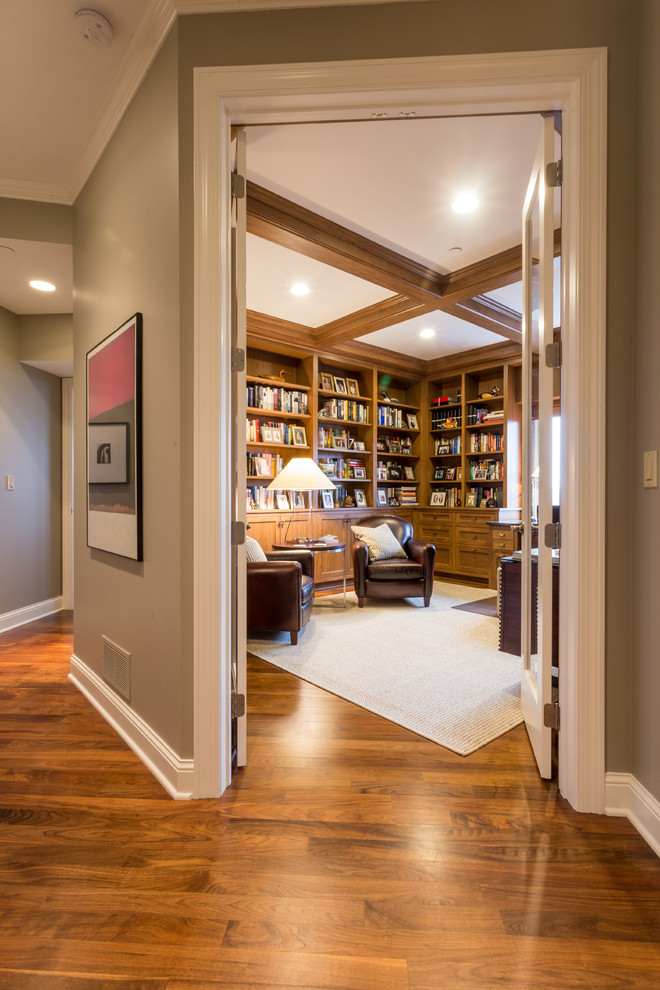 This is an example of a mid-sized traditional study room in Minneapolis with brown walls, medium hardwood floors, no fireplace and a built-in desk.