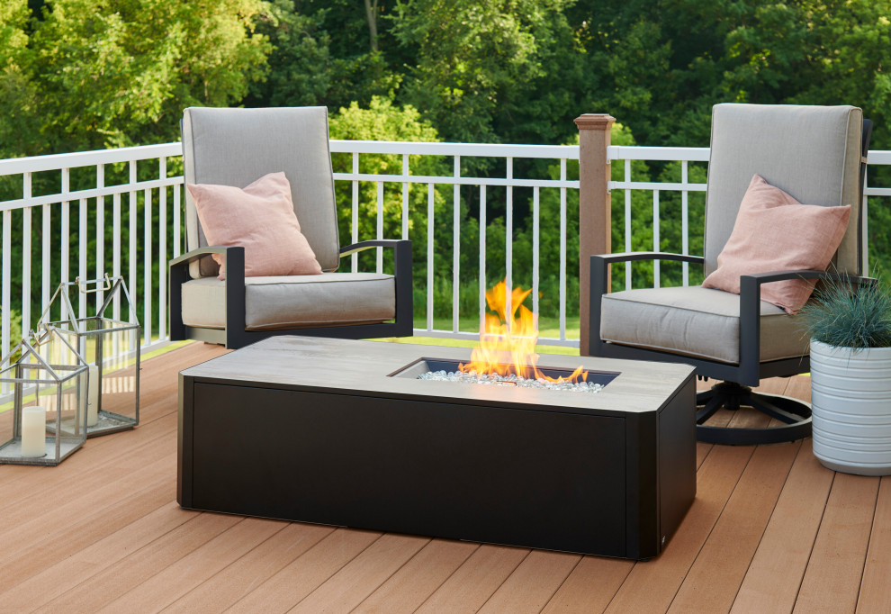 Inspiration for a mid-sized modern backyard and first floor deck in Minneapolis with a fire feature.