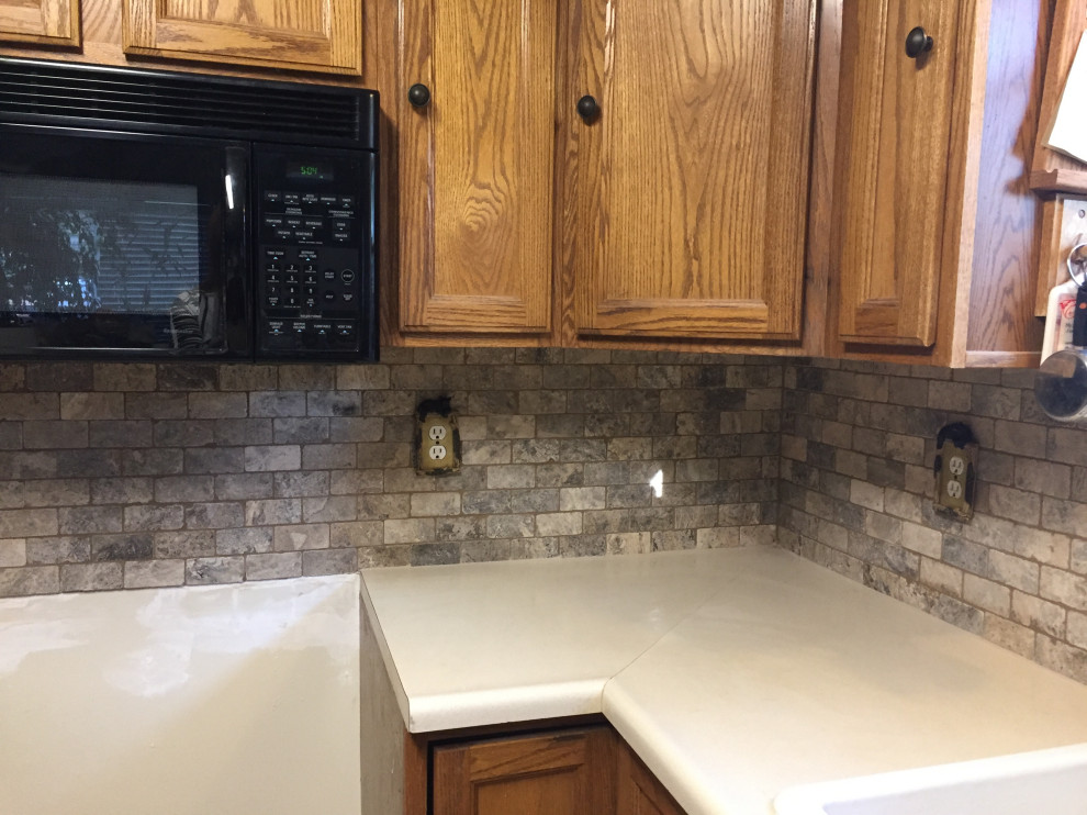 Inspiration for a mid-sized rustic eat-in kitchen remodel in Denver with stone tile backsplash