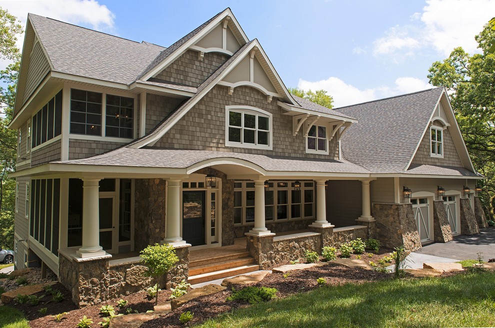 This is an example of a traditional two-storey grey exterior in Minneapolis with wood siding.