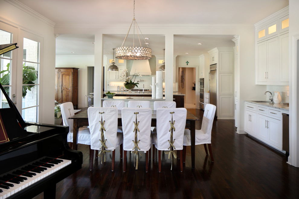 Photo of a mid-sized transitional open plan dining in New Orleans with white walls and dark hardwood floors.