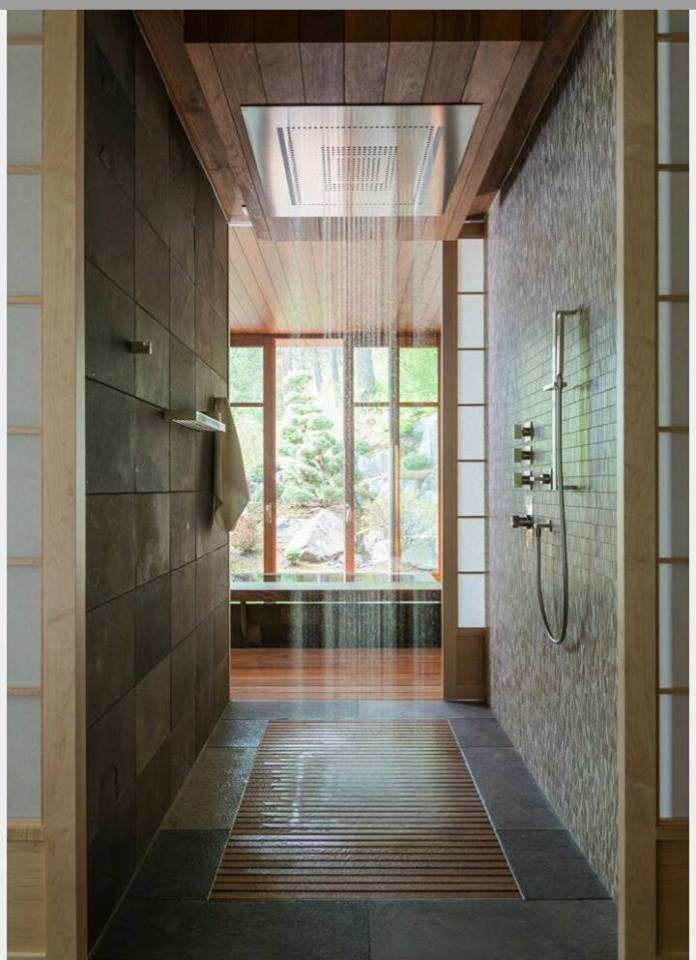 Large asian master bathroom in Seattle with an alcove tub, a curbless shower, brown tile, stone tile, beige walls and ceramic floors.
