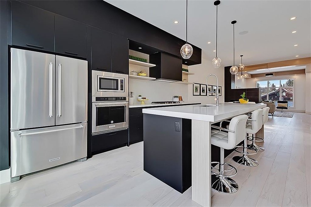 Design ideas for a mid-sized contemporary single-wall kitchen pantry in Calgary with an undermount sink, flat-panel cabinets, black cabinets, onyx benchtops, ceramic splashback, stainless steel appliances, terrazzo floors, with island and white floor.