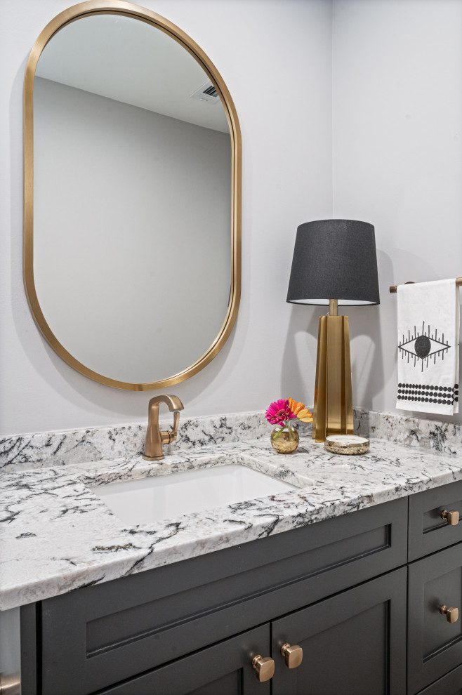 Small trendy 3/4 single-sink toilet room photo in Dallas with shaker cabinets, black cabinets, granite countertops, a built-in vanity and multicolored countertops
