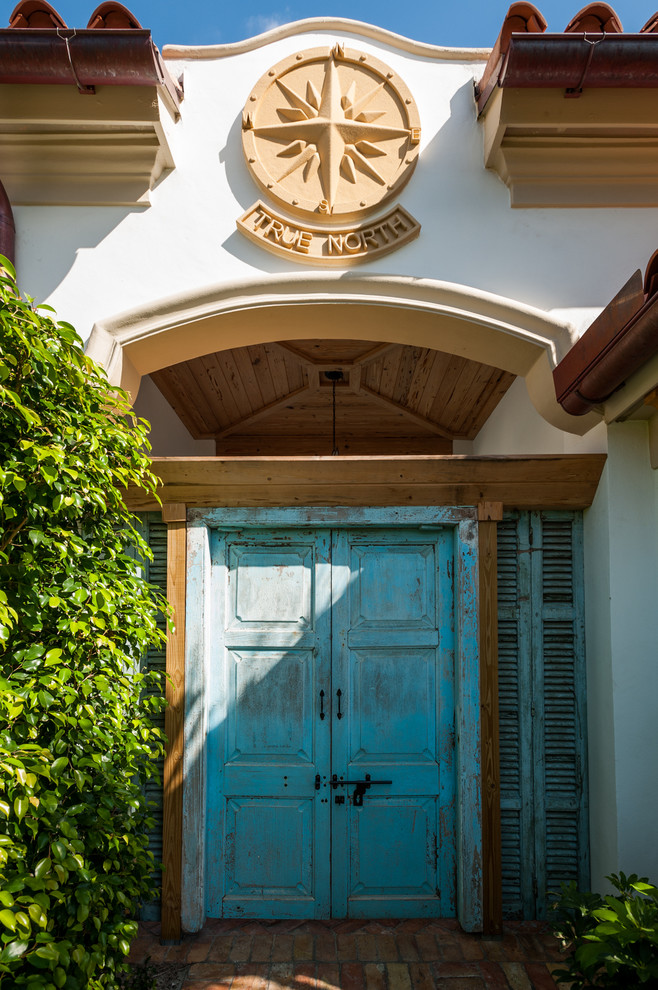 Inspiration for a mid-sized transitional front door in Miami with a double front door and a blue front door.