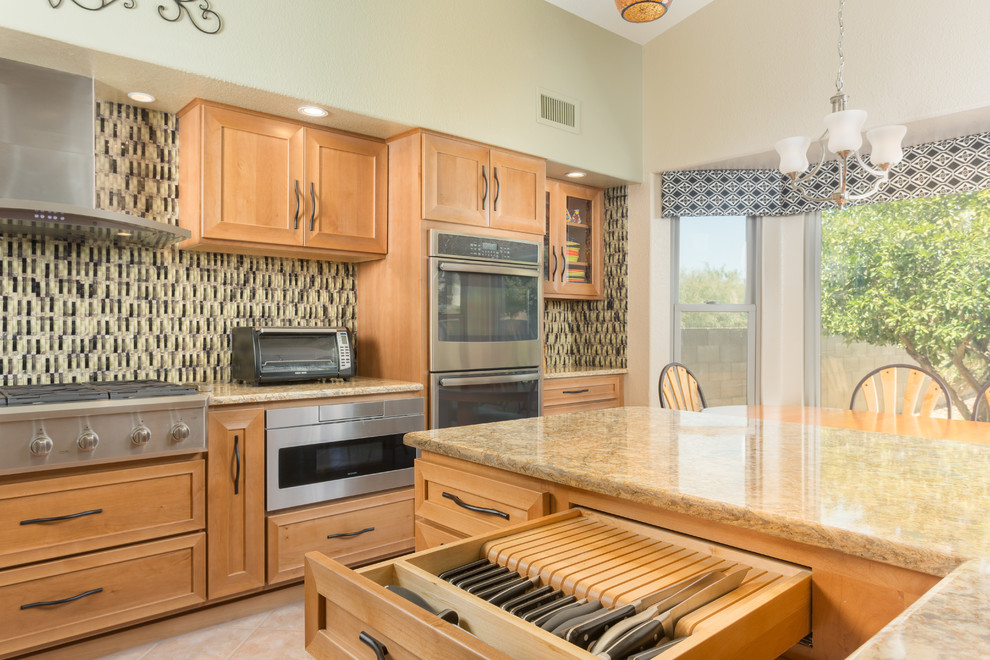 Example of a mid-sized trendy u-shaped porcelain tile open concept kitchen design with an undermount sink, recessed-panel cabinets, light wood cabinets, granite countertops, multicolored backsplash, glass tile backsplash, stainless steel appliances and an island