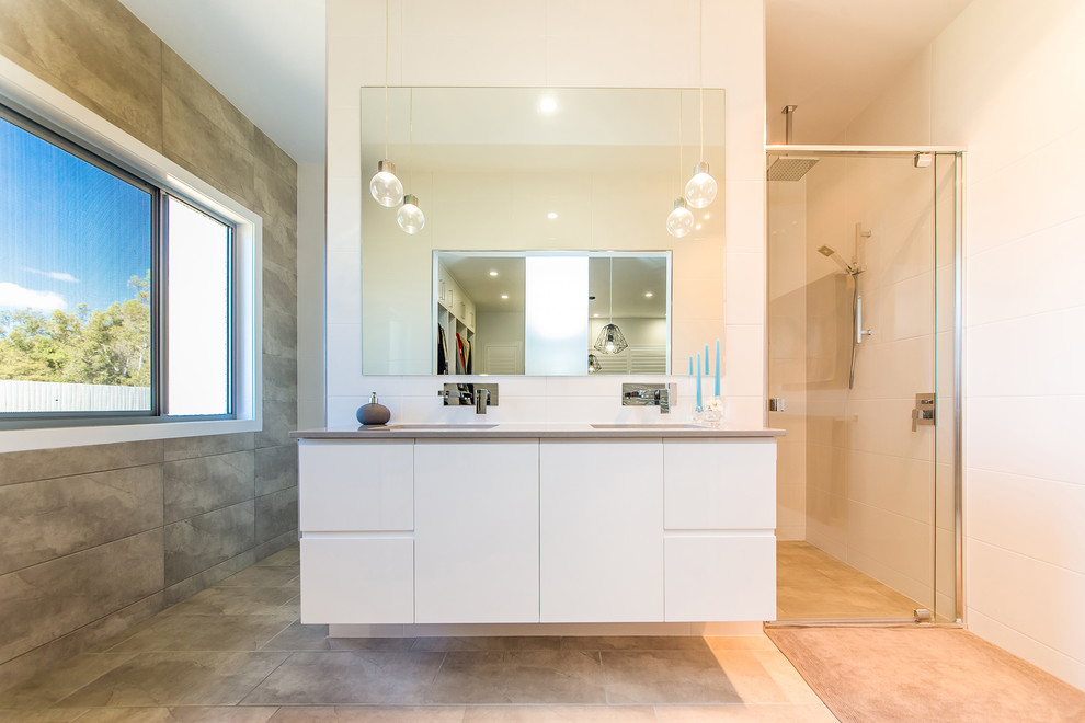 Design ideas for a modern bathroom in Brisbane with flat-panel cabinets, white cabinets and an alcove shower.