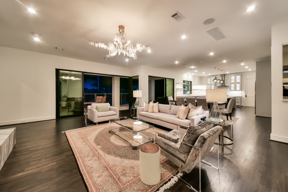 Photo of a large contemporary open concept living room in Houston with white walls, dark hardwood floors, a ribbon fireplace, a stone fireplace surround, a wall-mounted tv and brown floor.