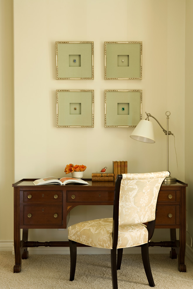 This is an example of a traditional home office in Los Angeles with beige walls, carpet and beige floor.