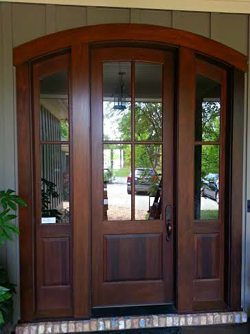 This is an example of a large traditional front door in Miami with a single front door and a dark wood front door.