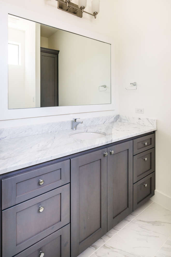 Photo of a large transitional master bathroom in Austin with flat-panel cabinets, brown cabinets, a freestanding tub, granite benchtops, a one-piece toilet, white walls, marble floors and a vessel sink.