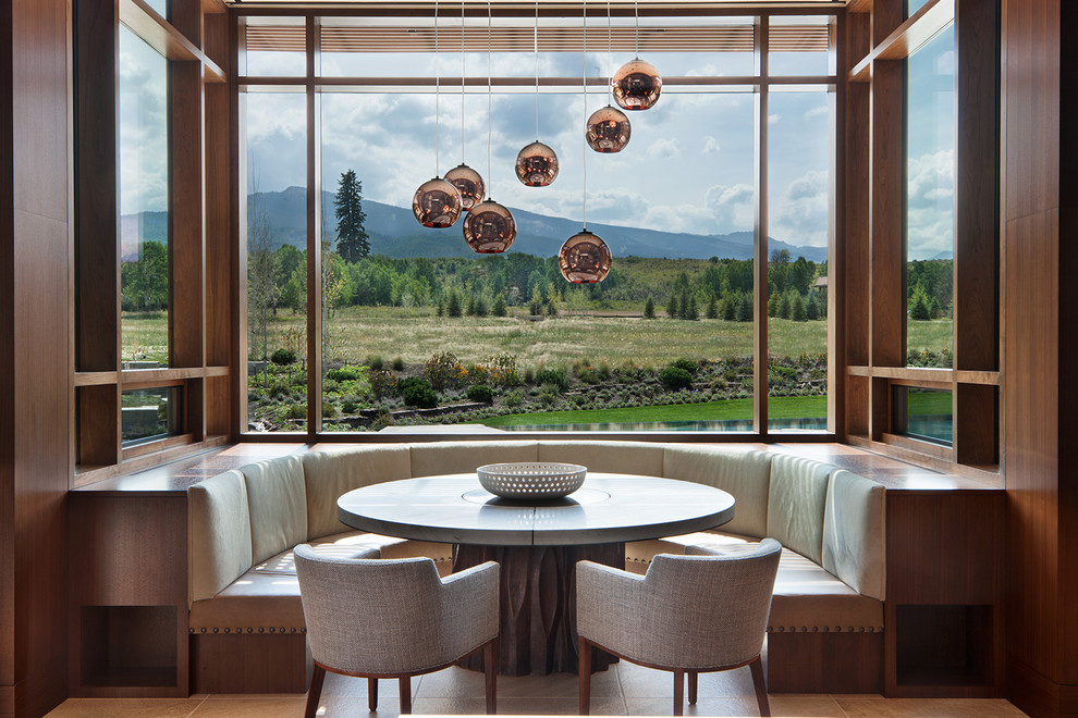 This is an example of an expansive country dining room in Denver.