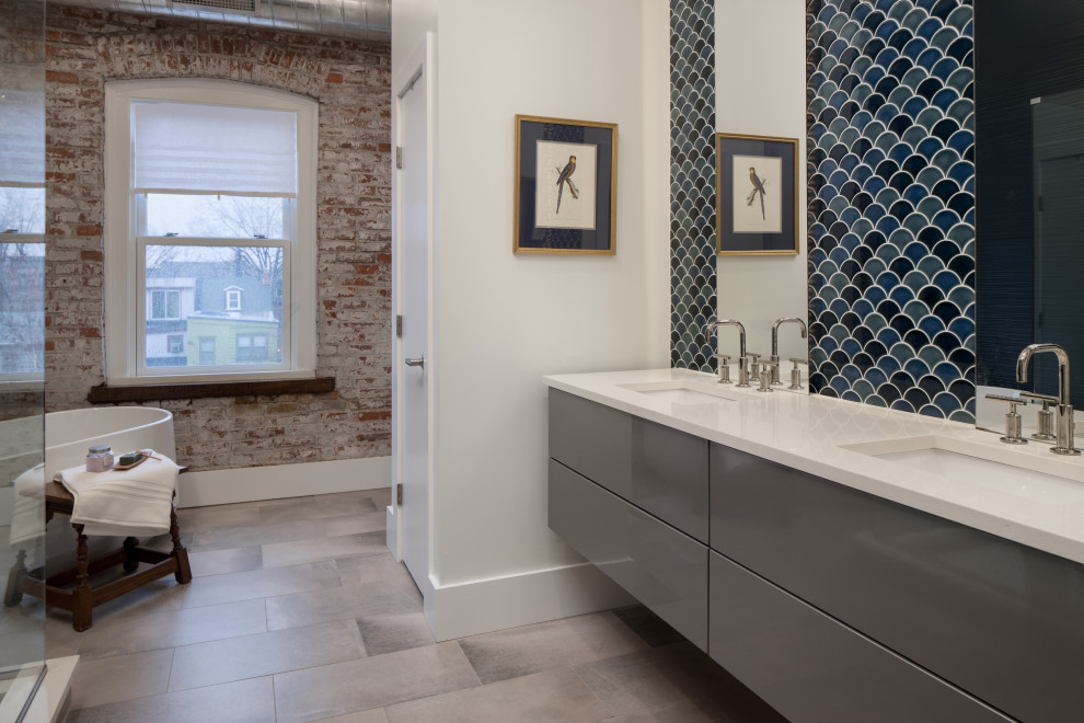 Photo of a small contemporary master bathroom in Other with flat-panel cabinets, grey cabinets, a freestanding tub, a curbless shower, black tile, blue tile, ceramic tile, multi-coloured walls, ceramic floors, an undermount sink, quartzite benchtops, beige floor, a hinged shower door, white benchtops, a double vanity and a floating vanity.