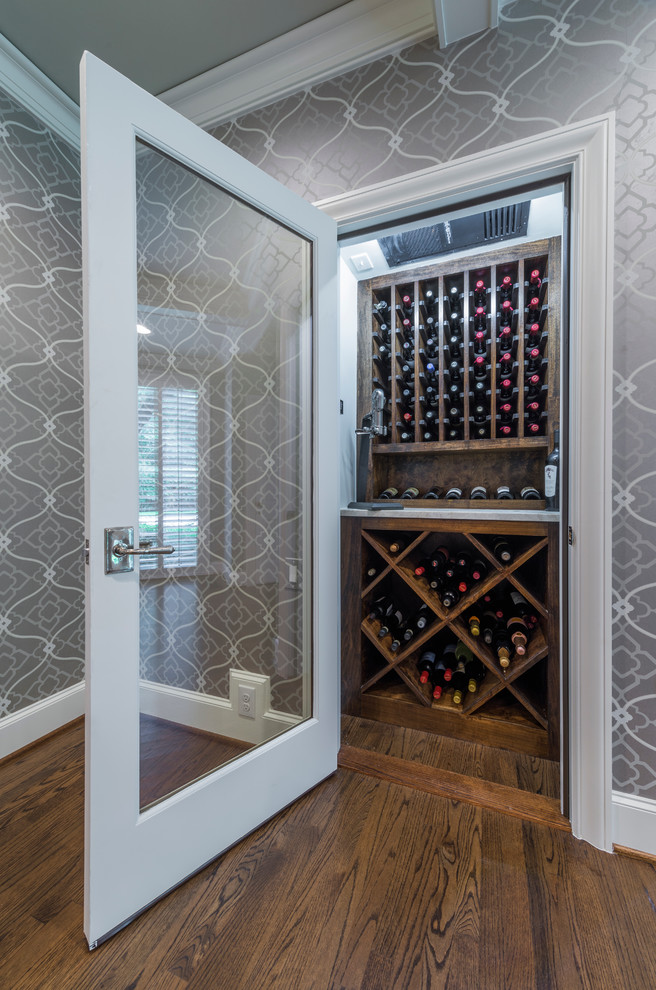 Photo of a small transitional wine cellar in Dallas with medium hardwood floors and diamond bins.