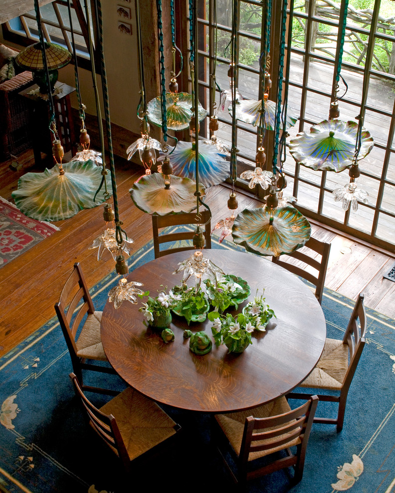 Design ideas for a mid-sized country open plan dining in New York with dark hardwood floors.
